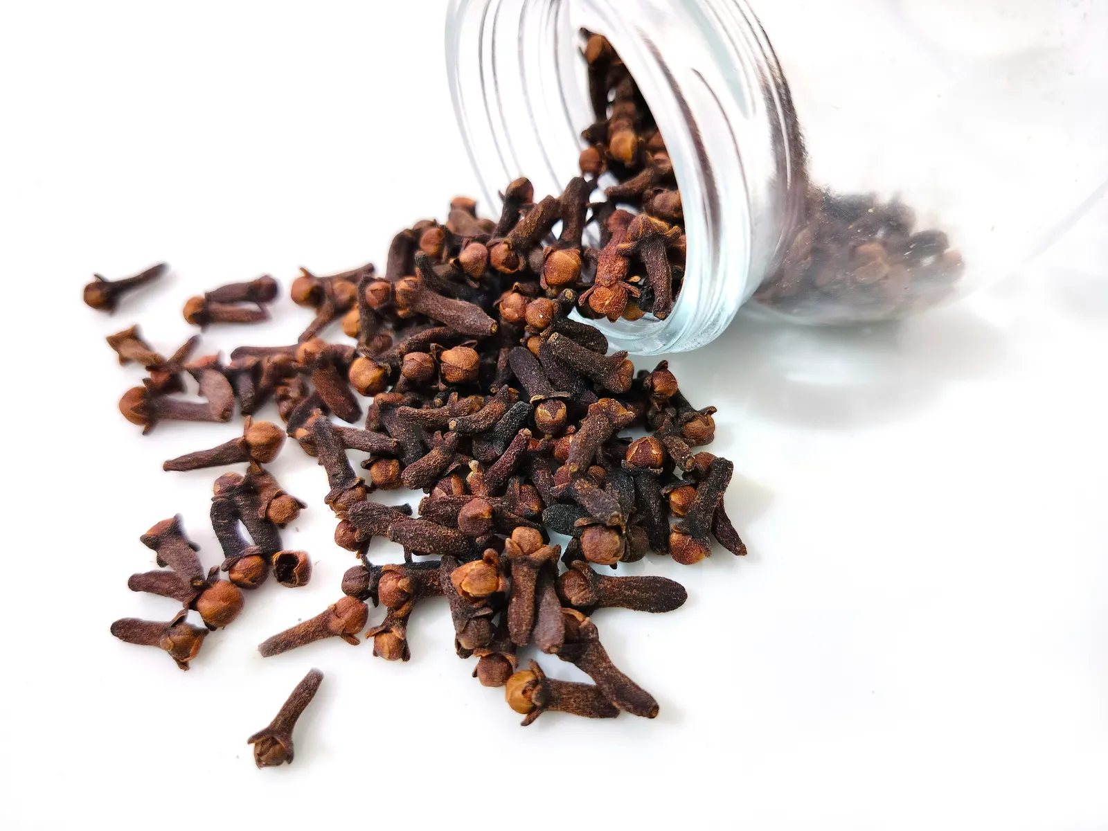 A glass jar filled with dried cloves