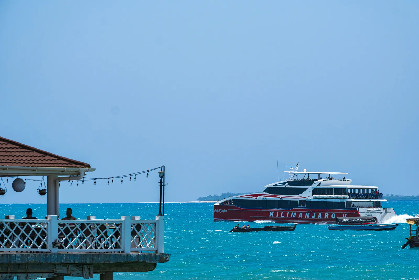 A passenger boat moored at a pier in calm water
