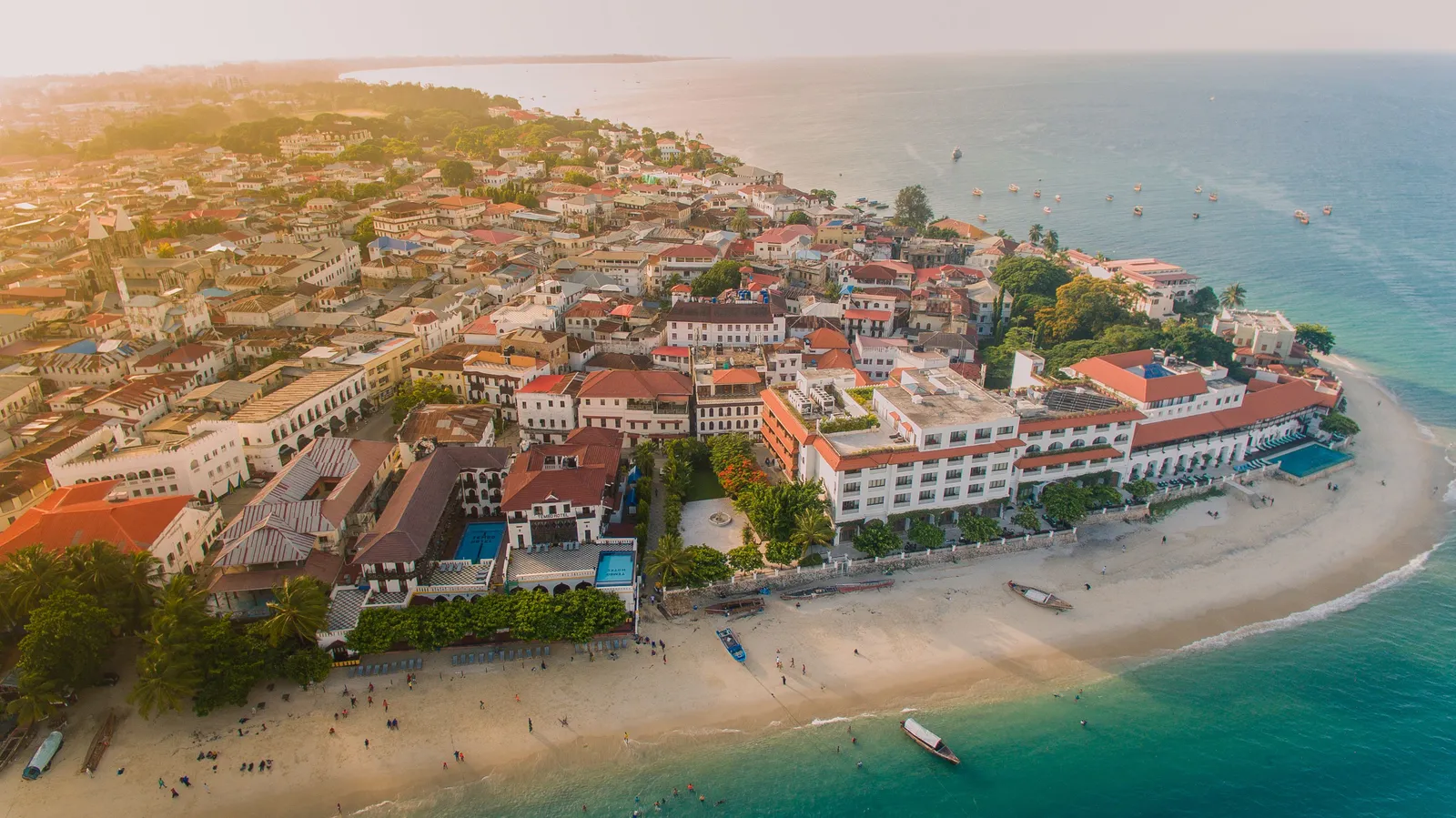 Aerial view over Stone Town's rooftops, sea and moored boats